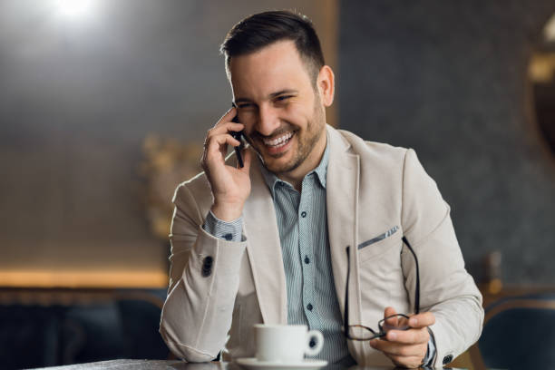istock Happy mid adult man talking on mobile phone in a cafe 1133677596