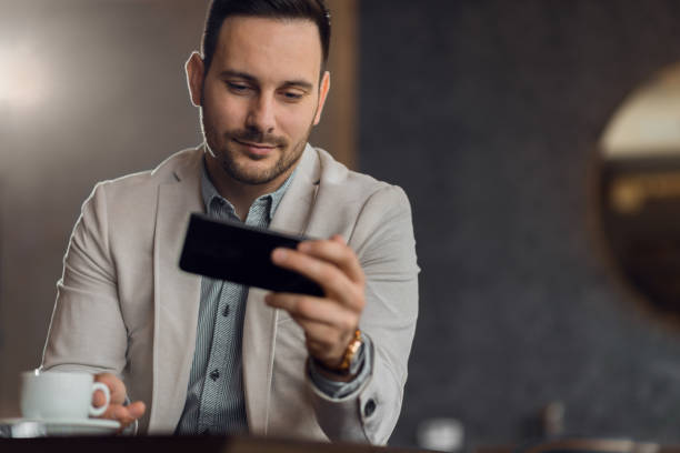 istock Mid adult businessman reading a text message on mobile phone 1133678057