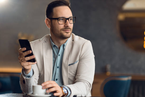 istock Mid adult businessman using cell phone in a cafe 1133678388