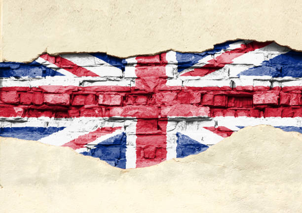 istock National flag of Great Britain on a brick background. Brick wall with partially destroyed plaster, background or texture. 1133679099