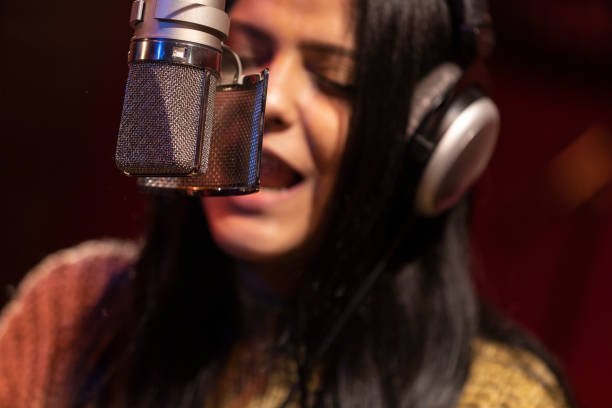 istock Famele singer performing for recording in sound studio 1133679144