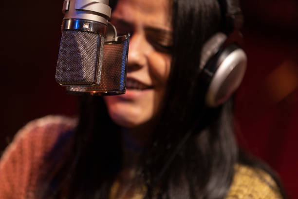 istock Famele singer performing for recording in sound studio 1133679906