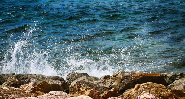 istock Ocean waves crashing on rocky shore. 1133680071