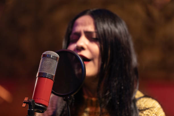 istock Famele singer performing for recording in sound studio 1133680173