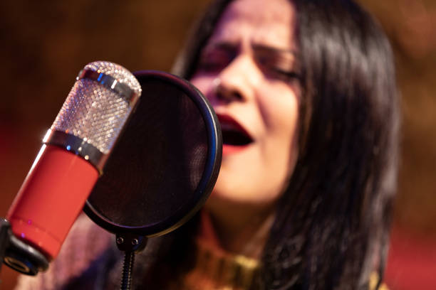 istock Famele singer performing for recording in sound studio 1133681125