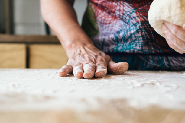 istock Skilled baker woman kneading dough. Professional bakery concept. 1133685209