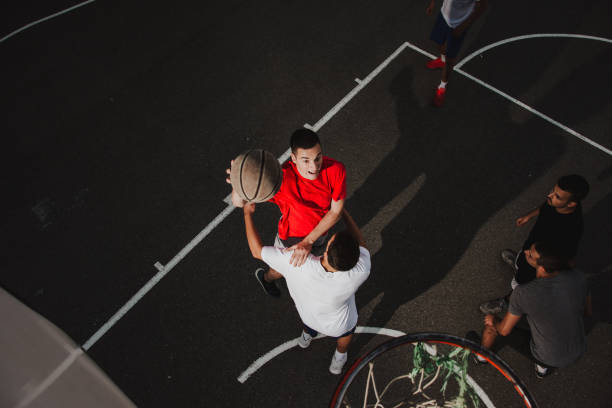 istock Group of friends playing basketball 1133685247