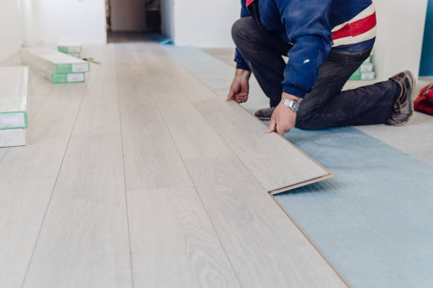 istock Professional worker Installing wooden laminate flooring tile home renovation 1133685400