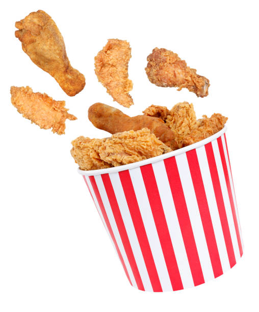 istock Perfect fried chicken pieces flying around in red white striped box 1133687689