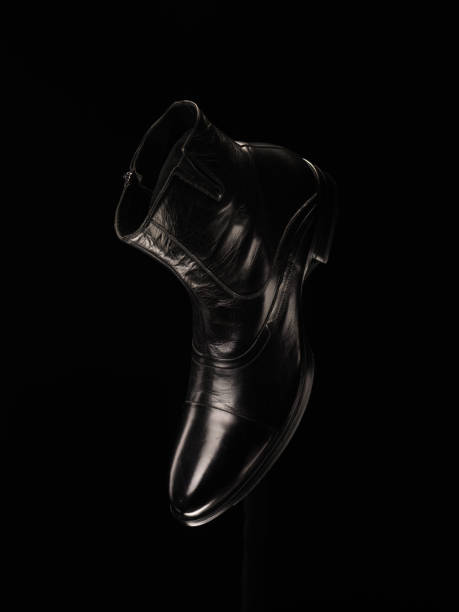 istock Black Leather man's boots isolated on black background 1133689489