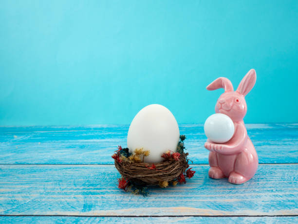 istock Easter eggs in the nest on bright blue wooden background 1133690701