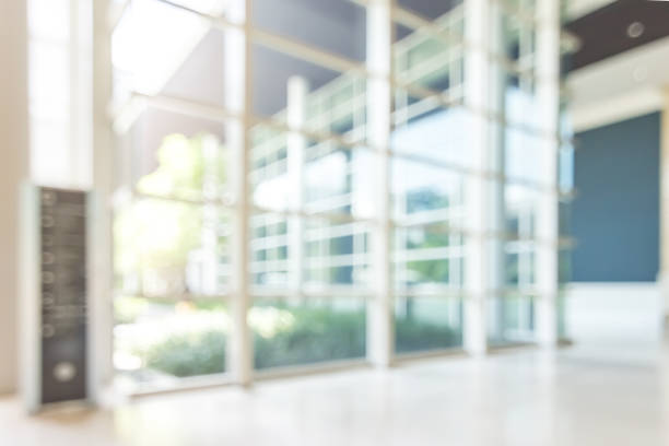 istock Blur hotel or office lobby background interior view toward reception hall, modern luxury white room space with blurry corridor and building glass wall window 1133692382