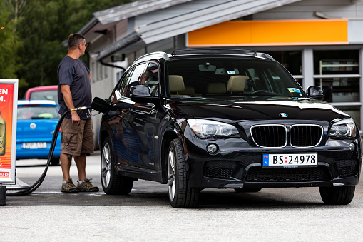 Driver refuels BMW car at a gas station in Oslo, Norway. BMW is a German multinational company which currently produces luxury automobiles and motorcycles, and also produced aircraft engines until 1945. The company was founded in 1916 and has its headquarters in Munich, Bavaria. BMW produces motor vehicles in Germany, Brazil, China, India, South Africa, the United Kingdom, and the United States. In 2015, BMW was the world's twelfth largest producer of motor vehicles, with 2,279,503 vehicles produced.