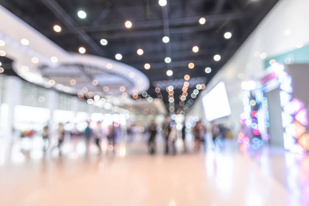 Exhibition event hall blur background of trade show business, world or international expo showcase, tech fair, with blurry exhibitor tradeshow booth displaying product with people crowd Exhibition event hall blur background of trade show business, world or international expo showcase, tech fair, with blurry exhibitor tradeshow booth displaying product with people crowd corridor photos stock pictures, royalty-free photos & images