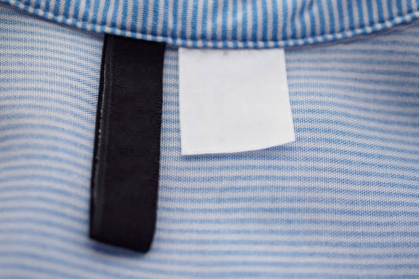 istock blank black and white clothing label on blue fabric texture background 1133692658