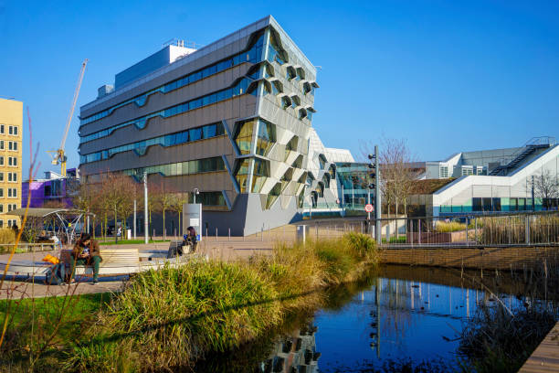 Coventry, UK - February 23, 2019: Image around Coventry University Metal Smart Engineering buildings and garden and lake and reflection of building