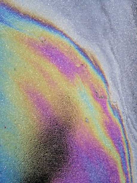 istock Multi colored oil spill on asphalt road, abstract background, 1133700439