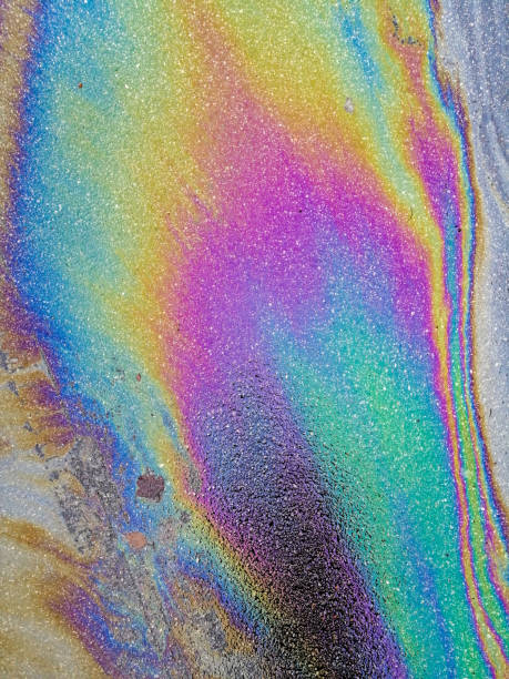 istock Multi colored oil spill on asphalt road, abstract background, 1133700442