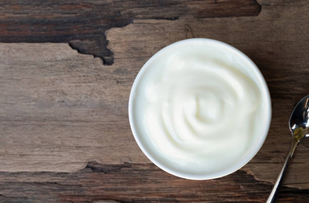 istock Yogurt  In white glass wood background. 1133703176