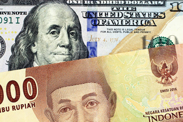 istock An American one hundred dollar bill with an Indonesian five rupiah note 1133705392