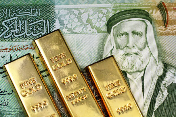 A close up image of a Jordanian dinar with small gold bars A close up image of a green Jordanian dinar bank note with three small gold bars dinar stock pictures, royalty-free photos & images