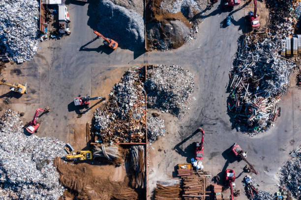 Aerial photograph of waste disposal site. Large amounts of iron scraps.
Many excavator cars are in operation. recyclable materials stock pictures, royalty-free photos & images