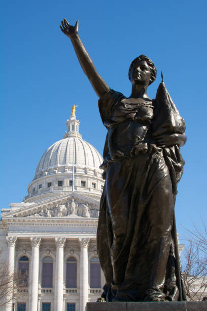 Statue and State Capital Statue with Wisconsin State Capital building in background.  Madison, Wisconsin, USA. wisconsin state capitol building stock pictures, royalty-free photos & images