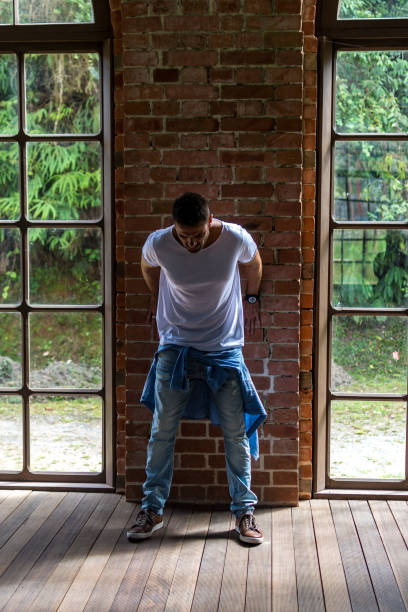 istock man in front of window 1133711649
