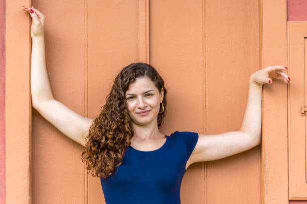 istock Young girl in front brick wall 1133711666