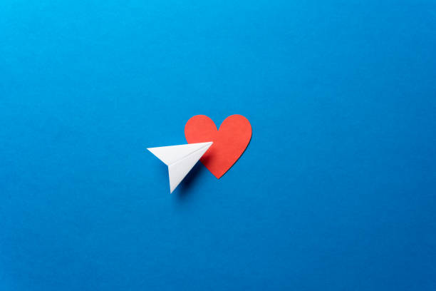 Paper airplane with red heart shape on blue background. Sharing and send symbol concept. Airplane flight transport sign. Landing page concept. Paper airplane with red heart shape on blue background. Sharing and send symbol concept. Airplane flight transport sign. Landing page concept. Paper plane email web message sending. paper airplane photos stock pictures, royalty-free photos & images