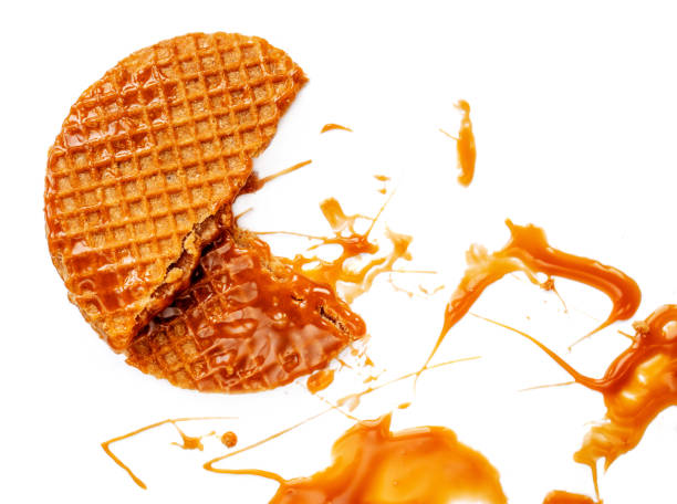 istock Caramel thin round waffle with Caramel sauce isolated on white background. Dutch stroopwafel with Golden Butterscotch toffee syrup, top view 1133716466