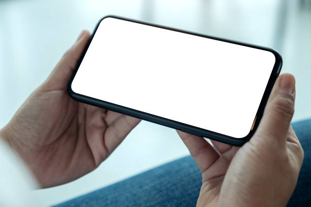 istock a woman holding black mobile phone with blank desktop screen horizontally 1133717868