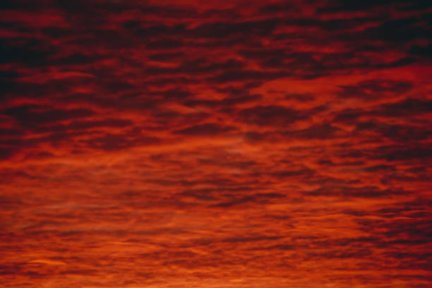 istock Fiery red blood vampire dawn. Amazing warm dramatic fire cloudy sky. Vivid orange sunlight. Atmospheric background of sunrise in overcast weather. Hard cloudiness. Storm clouds warning. Copy space. 1133719577