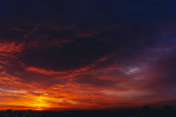 istock Fiery red blood vampire dawn. Amazing warm dramatic fire blue dark cloudy sky. Orange sunlight. Atmospheric background of sunrise in overcast weather. Hard cloudiness. Storm clouds warning. Copy space 1133719592