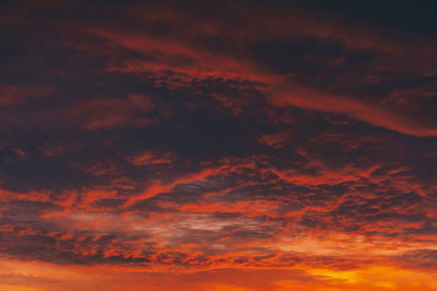 istock Fiery red blood vampire dawn. Amazing warm dramatic fire cloudy sky. Vivid orange sunlight. Atmospheric background of sunrise in overcast weather. Hard cloudiness. Storm clouds warning. Copy space. 1133719596