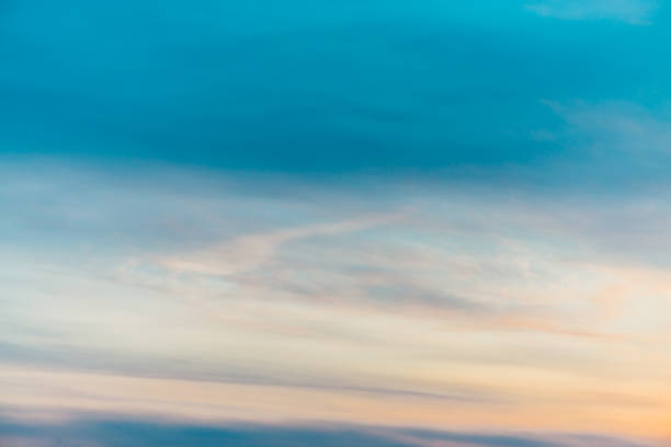 istock Sunset sky with orange yellow light clouds. Colorful smooth blue sky gradient. Natural background of sunrise. Amazing heaven at morning. Slightly cloudy evening atmosphere. Wonderful weather on dawn. 1133719603