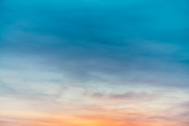 istock Sunset sky with violet yellow light clouds. Colorful smooth blue sky gradient. Natural background of sunrise. Amazing heaven at morning. Slightly cloudy evening atmosphere. Wonderful weather on dawn. 1133719604