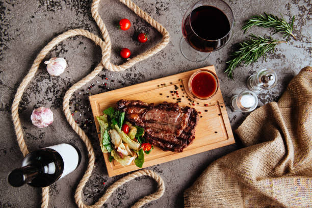 istock Sliced prime ribeye steak on black stone plate. 1133720036
