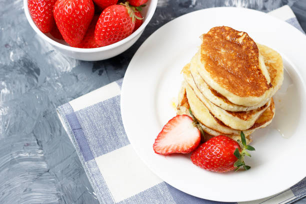 istock Pancakes on a plate and strawberries on a gray background 1133720069