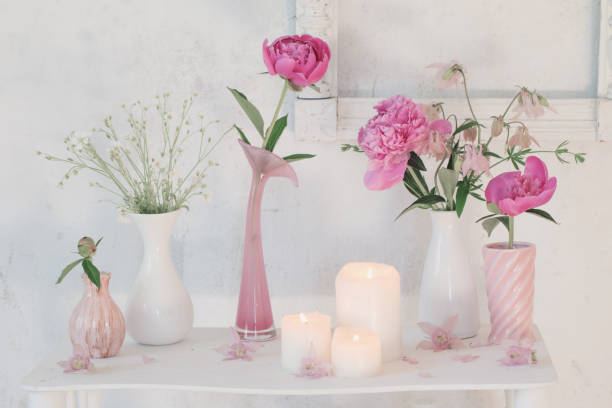 istock flowers in vases and candles on white background 1133723100