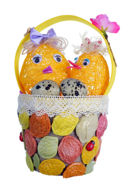Easter handmade  basket  from rope and pasta  with funny chickens and guail eggs. Isolated