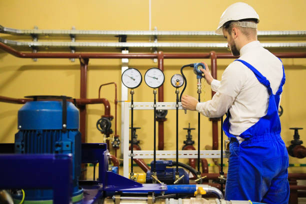 istock Engineer adjusts pressure sensors on industrial refinery plant 1133726540