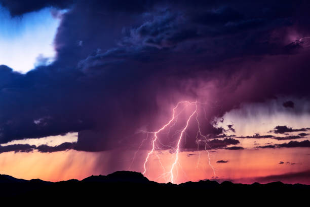 istock Lightning bolt strike in a storm at sunset. 1133727678