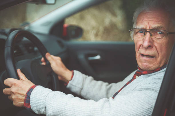 istock Old gentleman drives car and makes a angry face 1133728932