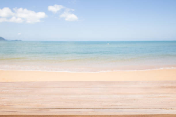 istock Empty wood table with Blur abstract of Sand and soft wave at the beach background. 1133730557