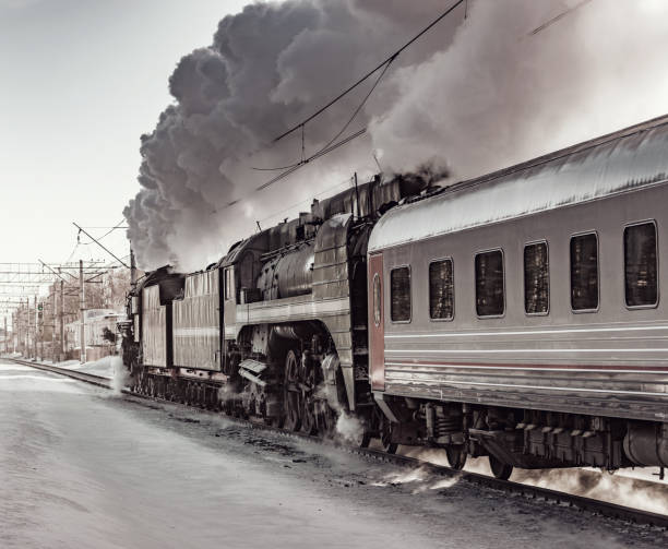 istock Steam train moves toward at cold winter morning time. 1133731256