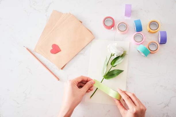istock Making decorations or greeting card. Paper strips, flower, scissors. Handmade crafts on holiday: Birthday, Mother's or Father's Day, March 8, Wedding. 1133732598