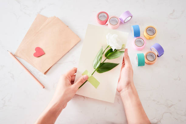 istock Making decorations or greeting card. Paper strips, flower, scissors. Handmade crafts on holiday: Birthday, Mother's or Father's Day, March 8, Wedding. 1133732599