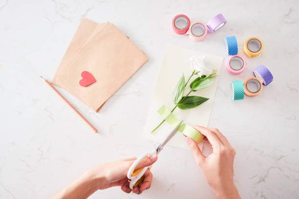 istock Making decorations or greeting card. Paper strips, flower, scissors. Handmade crafts on holiday: Birthday, Mother's or Father's Day, March 8, Wedding. 1133732602