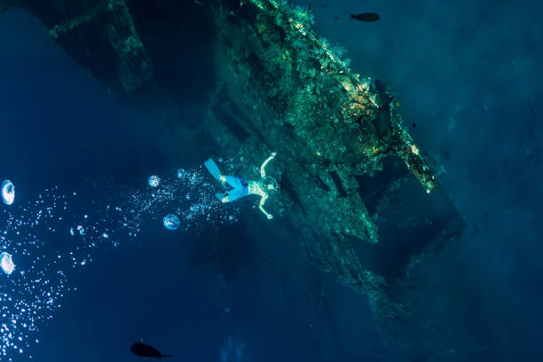 istock Freediver man make bubbles at underwater shipwreck, Bali 1133732623